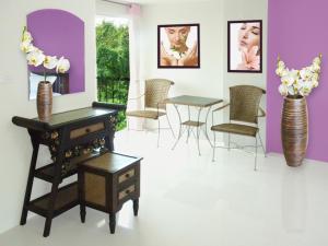 a room with a table and chairs and flowers at Spa Guest House in Jomtien Beach