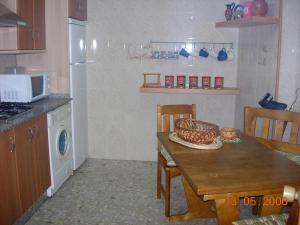 a kitchen with a table with a bowl on it at Apartamento Mayte in Conil de la Frontera