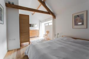 a white bedroom with a bed and a desk at Owl Barn at Penygaer Great views of Brecon Beacons in Llandovery