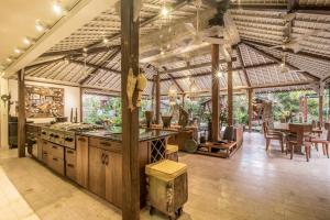 a large kitchen with a counter and a table at Wayang Retreat in Canggu