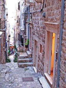 een steegje in een oude stad met trappen en gebouwen bij Villa Leora Dubrovnik in Dubrovnik