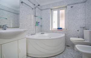 a bathroom with a tub and a sink and a toilet at Villa Leora Dubrovnik in Dubrovnik +4 photos