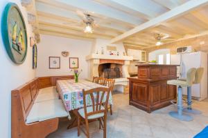 a kitchen and dining room with a table and a fireplace at Villa Leora Dubrovnik in Dubrovnik