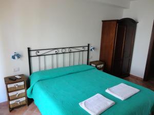 a bedroom with a bed and a desk at Bed and Breakfast Ichnos in Cala Gonone