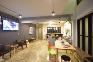 a living room with a table and chairs at The Chatbox Silom Hostel in Bangkok