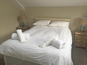 a bed with two rolls of toilet paper on it at The Waterfront Inn in Westward Ho