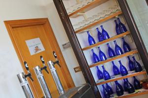 un montón de jarrones azules en un estante junto a una puerta en Hotel Touring, en Misano Adriatico