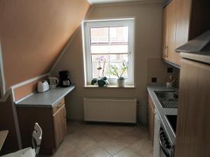 a small kitchen with a sink and a window at Lovely Apartment in Neubukow near Sea in Neubukow