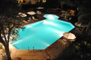 uma vista superior de uma piscina à noite em Niki Hotel Apartments em Ialyssos