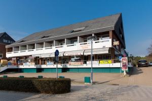 a building on a street with a parking lot at Seewind in Sankt Peter-Ording
