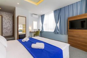 Katil atau katil-katil dalam bilik di Privilege Suites by Central Park