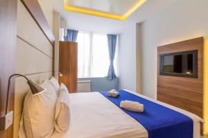 Katil atau katil-katil dalam bilik di Privilege Suites by Central Park
