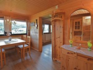 a kitchen and dining room in a log cabin at Holiday home with private garden in Waltershausen