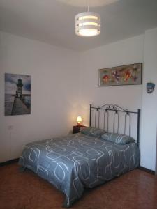 a bedroom with a bed and a lamp and a light at Goyo Gomera Apartments in Valle Gran Rey