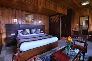 a bedroom with a bed and a table with flowers at Zone Connect by The Park Mount Siniolchu, Gangtok in Gangtok +38 photos