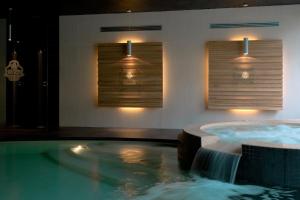 a bathroom with a tub with a water fountain at Cascina Scova Resort in Pavia