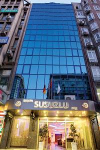 a glass building with a sign in front of it at Susuzlu Seckin Hotel in İzmir