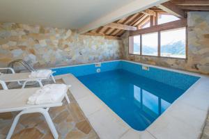 a pool in a room with a table and a table and a tablektopktop at Le Refuge in La Rosière