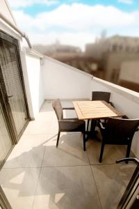 a table and chairs on a balcony with a view at Gardenya Suite Hotel in Trabzon