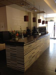 a bar in a restaurant with a counter at Arcohotel in San Mateo de Gállego