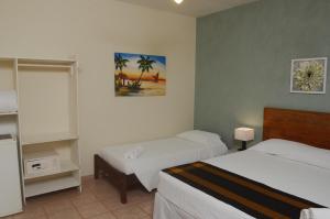 Cama ou camas em um quarto em Pousada Villa Maritima