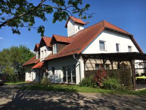 a large white house with a red roof at Hotel garni Zur Mühle in Angermünde