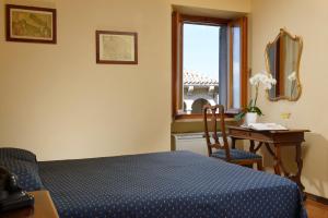 Postel nebo postele na pokoji v ubytování Hotel Titano