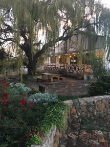 a park with a picnic table and a tree at Riverview Country Inn in Van Reenen