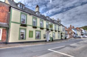 a row of buildings on the side of a street at Dunster Castle Hotel in Dunster
