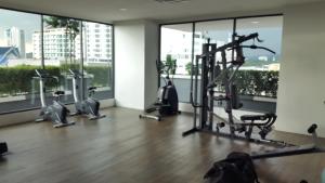 a gym with treadmills and exercise bikes in a room with windows at Vista Alam in Shah Alam