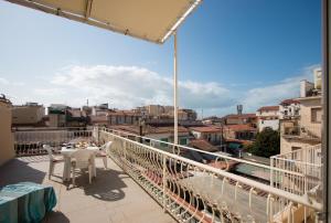 a balcony with a table and a view of a city at Attico con 2 camere in Via Vespucci in Viareggio