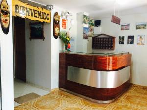 a bar in a restaurant with a sign on the wall at Hostal Oro Verde-Villa Rica in Villa Rica