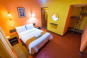 Rúm í herbergi á Hotel Kuntur Wassi