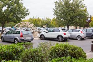 a group of cars parked in a parking lot at studio Vaucluse Clovis in L'Isle-sur-la-Sorgue