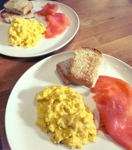 two plates of eggs and bread on a table at Mount Pleasant Farm in Wedmore