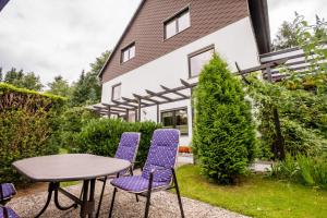 a table and chairs in front of a house at Haus Fernblick in Bad Grund