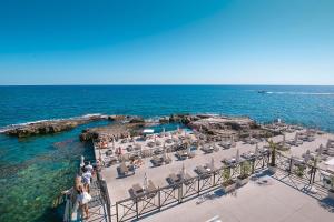 an aerial view of a beach with chairs and the ocean at Casa Graziosa in Siracusa
