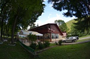 a building with a car parked in front of it at Popas Azuga in Azuga