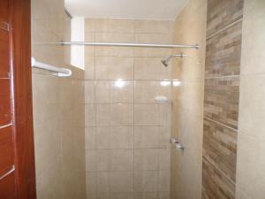 a bathroom with a shower with a glass door at D' Barrig in Trujillo +57 photos