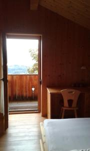 a room with a bed and a window and a desk at Leitenschneider Hütte in Waggendorf