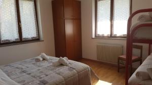 Posteľ alebo postele v izbe v ubytovaní Appartamento Lago