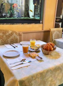 a table with a plate of food and drinks on it at B&B Villa Primavera in Pisa