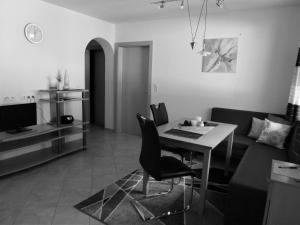 a living room with a table and a couch at Ferienwohnung Hannes Steirer in Neustift im Stubaital