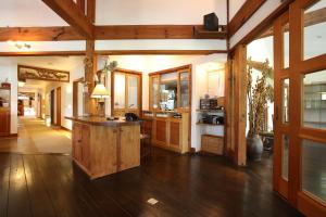 a large kitchen with wooden cabinets and a island at Momiji in Otari