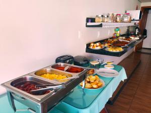 a buffet with many different types of food on a table at MS Palace Hotel in Cláudio