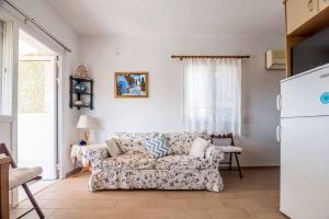 a living room with a couch and a refrigerator at Maria's House in Katelios