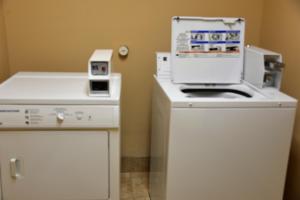 a kitchen with a machine on top of a refrigerator at Irish Inn and Suites in Muleshoe