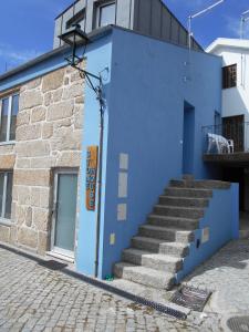 a blue building with stairs on the side of it at Stone House in Sabugueiro