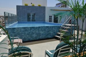 a swimming pool on the roof of a building at Country Hotel in Chimbote