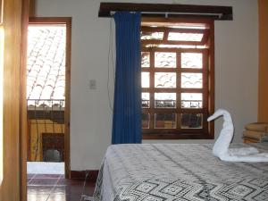 Una cama o camas en una habitación de Hotel La Casona